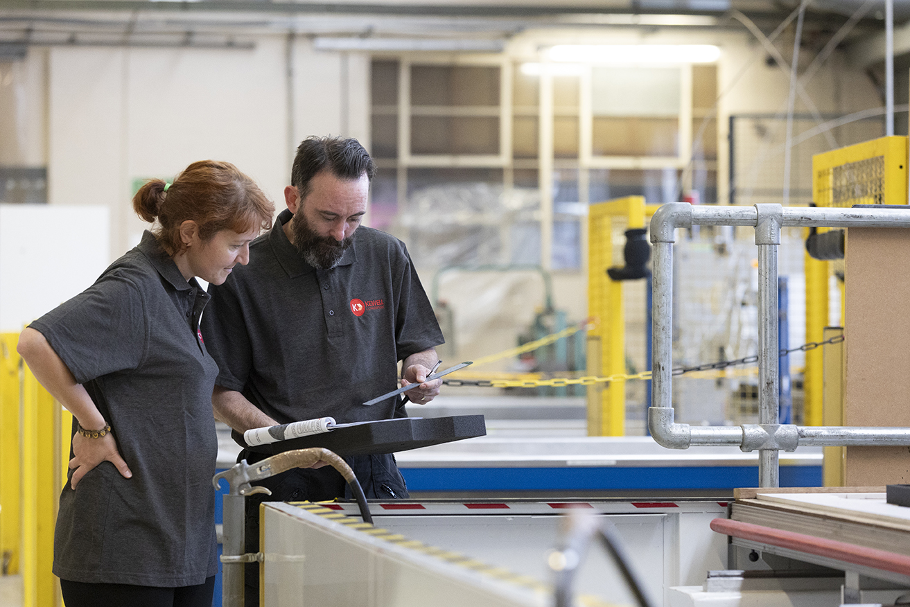 Our skilled engineers deep in discussion in the factory