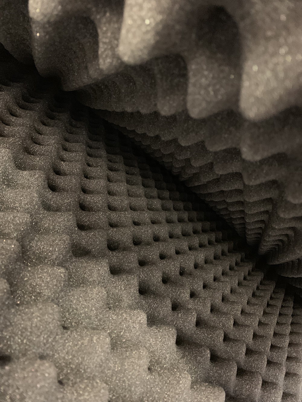 acoustic foam, usually made into blocks with surface of these tiles often features pyramid, cone, wedge, or uneven cuboid shapes.