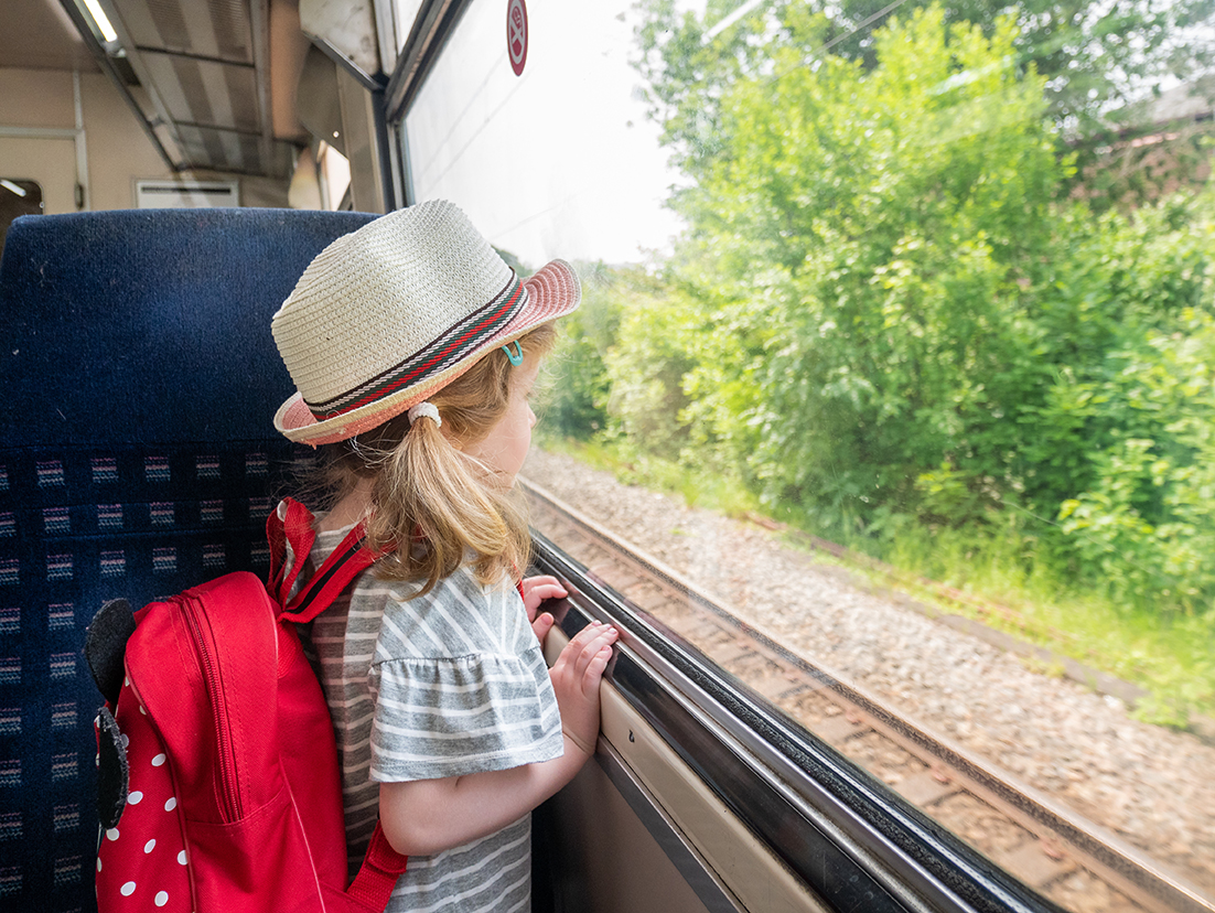 Girl looking out of the window of the speed train